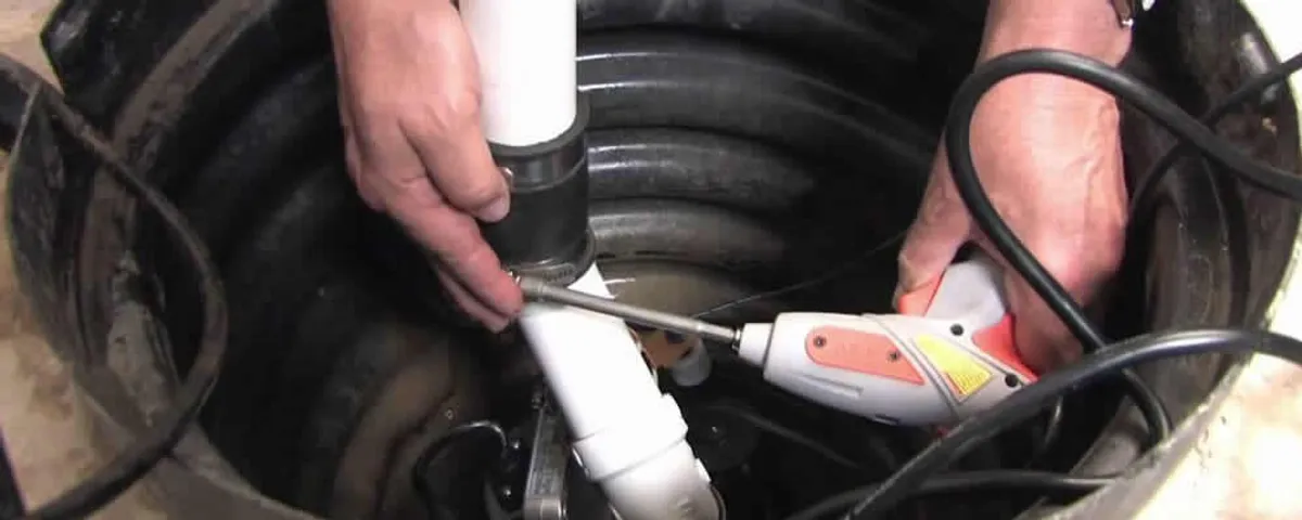 Sump pump installation technician connecting PVC discharge piping in Glendale, AZ